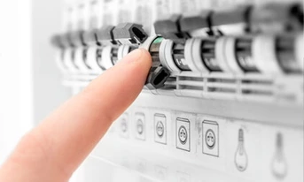 Someone pressing a switch, electrical services, property maintenance London